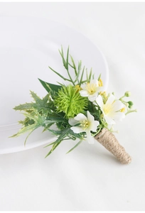 Detail of handmade wedding boutonniere with white flowers and natural jute rope wrapping