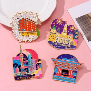 Macro shot of colorful enamel Shanghai landmark magnets with gold metal finish and SHANGHAI logo