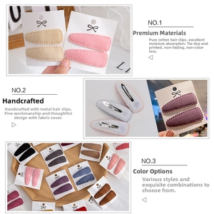 Detailed view of handmade cotton hair clips showing fabric texture and metal clip interior