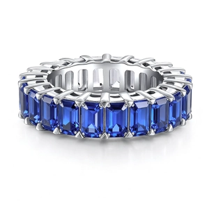Macro detail of silver eternity ring featuring rectangular-cut blue carbon diamonds