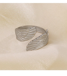 Detailed macro view of silver feather wing ring with intricate textured engraving