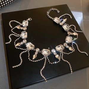 Close-up of sparkling square rhinestones and silver fringe tassel necklace details