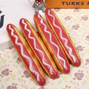 Detailed view of four creative 3D hot dog shaped ballpoint pens on floral background