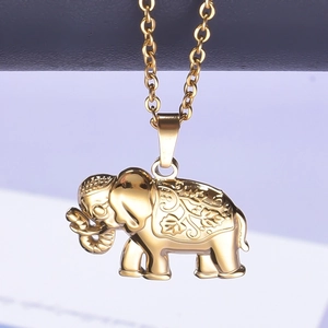 Detailed close-up of golden elephant pendant featuring intricate engraved floral patterns