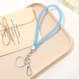 Blue glitter woven rope keychain with silver metal ring and swivel hook on tray