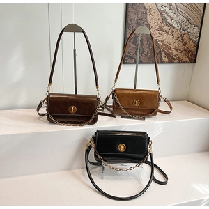 Detailed display of retro faux leather underarm bags in brown and black with gold clasps