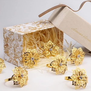 Set of 6 gold flower napkin rings with crystal center in a luxury Amour éternel gift box