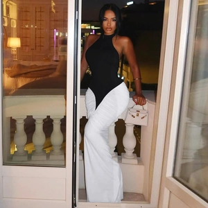 Detail of elegant black halter top and white pleated maxi skirt with a slim fit design