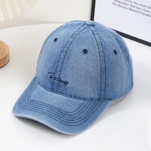 Vintage washed denim baseball cap with Forever embroidery shown in a cozy setting