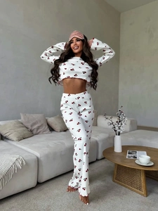 Detail of cherry print pajamas set with flared ruffled sleeves and matching pink eye mask