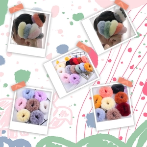 Close-up of colorful plush hair scrunchies with fluffy fur texture in various pastel colors