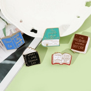 Detailed close-up of colorful enamel book pins with creative letterings and metal textures