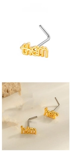 Detail of L-shaped nose studs with gold lettering designs including him, her and them