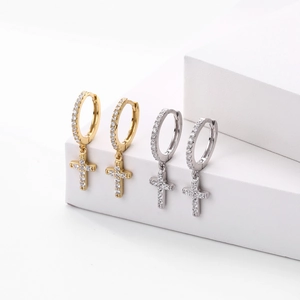 Detail of silver and gold cross hoop earrings with sparkling cubic zirconia inlay