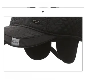 Detail of black diamond quilted thermal baseball cap with integrated ear flaps