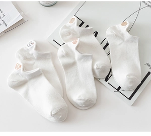 Close-up of white cotton low-cut socks featuring a cute bunny embroidery on the heel
