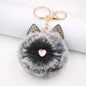 Close-up of leopard ear plush cat head keychain with heart nose and gold lobster clasp
