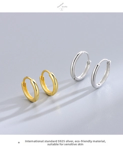 Macro detail of S925 sterling silver hoop earrings set in gold and silver finishes