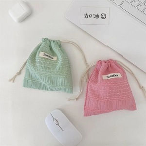 Detailed view of grid-textured cotton drawstring bags for cosmetics and travel essentials