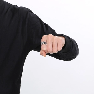 Close-up of silver Cuban link chain ring for men showing metallic texture on finger