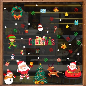 Detailed view of Santa, snowman and Christmas tree static cling stickers on a window pane