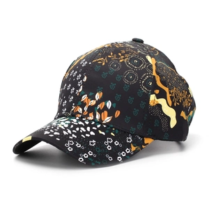 Detailed view of colorful floral pattern print on a black cotton baseball cap