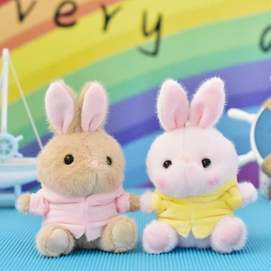 Close-up of cute plush bunny toys wearing colorful hoodies for gift decoration