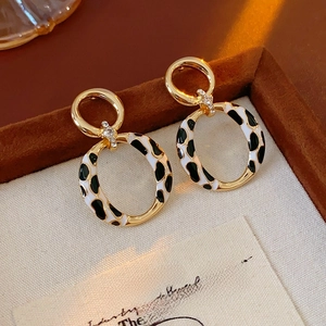 Detailed view of vintage leopard print oval hoop earrings with gold trim and rhinestones