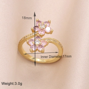 Detail view of gold floral ring with pink zircon stones and clear crystals