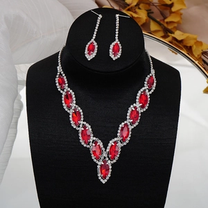 Detail of red marquise crystal necklace and earring set with silver rhinestone plating