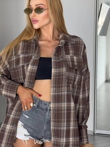 Detail view of brown plaid long sleeve shirt with classic checkered pattern and loose fit