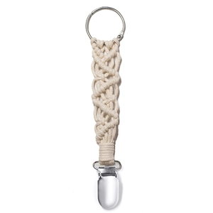 Close-up of a handmade woven cotton travel hat clip with durable metal clasp on white background