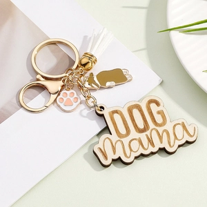 Detail of wooden Dog Mama keychain with corgi charm, paw pendant and white tassel