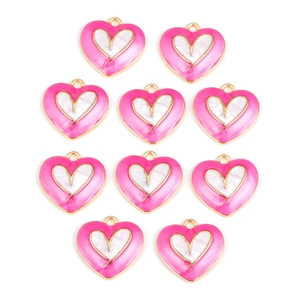 Detailed view of ten pink heart-shaped pendants with gold borders and shell inlay