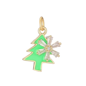 Detail view of a green enamel Christmas tree pendant with gold trim and snowflake crystals