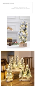 Mini frosted Christmas tree with warm LED lights and a natural wooden base detail