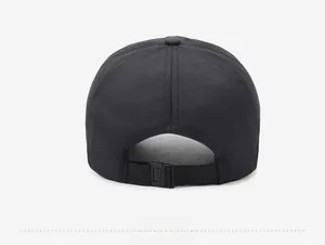 Detail view of the black baseball cap showing the adjustable buckle and woven fabric texture