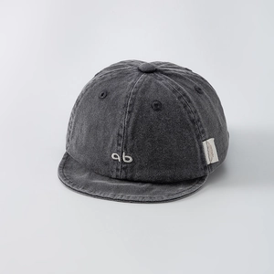 Detailed view of dark grey washed cotton kids cap with white ab letter embroidery