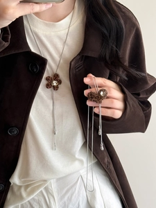 Detail of vintage long necklaces with leopard print flower and heart shaped pendants