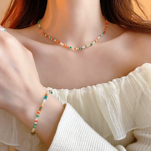 Colorful beaded jewelry set with necklace and bracelet in vibrant summer seed bead style