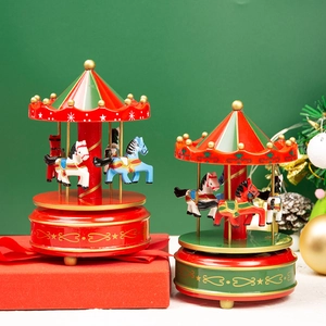 Christmas carousel music box decoration in red and green with festive gift boxes