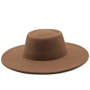 Detail view of the fine stitching and wool felt texture on the wide brim of a tan fedora