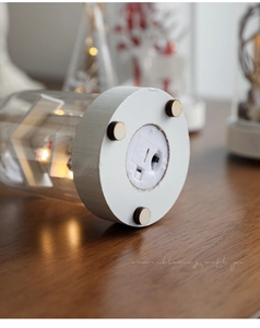 Close-up of the battery compartment and on-off switch on the base of Christmas glass lamp