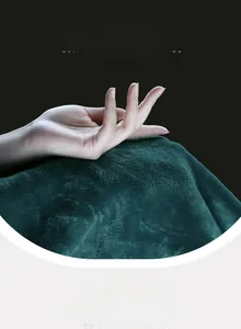 Close-up of soft emerald green flannel robe fabric showing premium plush texture