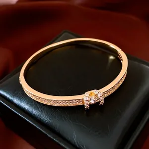 18K gold plated oval bangle with micro-paved crystals and central brilliant diamond