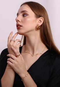 Model wearing 18K gold plated jewelry set with white heart charms and necklaces