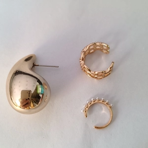 Detailed view of three-piece gold ear cuff set with pearls and polished droplet design