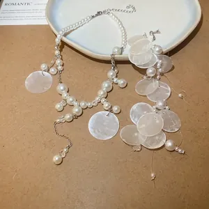 Elegant pearl and mother-of-pearl tassel necklace set with silver metal chain decor