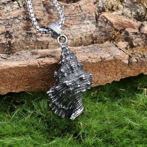 Detailed view of sea shell stainless steel pendant on a rustic wood and moss setting