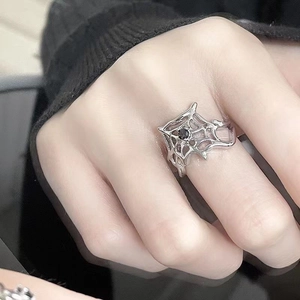 Detailed close-up of dark gothic spider web ring with a central black gemstone inlay